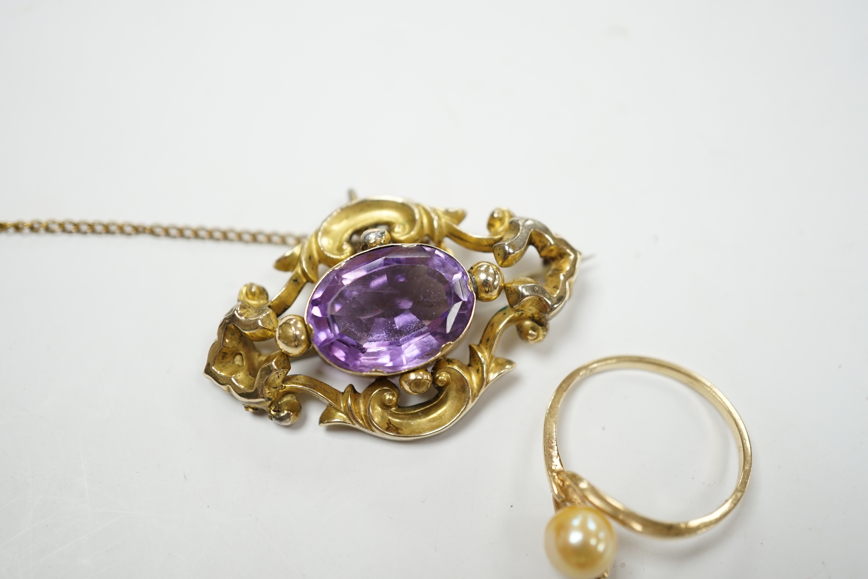 A late Victorian yellow metal mounted amethyst brooch, 38mm pendant and a 10k, cultured pearl and diamond set two stone ring.